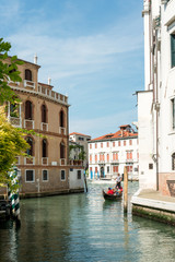 VENICE,ITALY-June 30, 2016.Tourists on water street with Gondola in Venice. its entirety is listed as a World Heritage Site, along with its lagoon.June 30, 2016 VENICE,ITALY