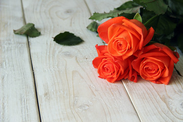 Bouquet of red roses on a wooden background