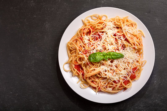plate of pasta with tomato sauce and parmesan
