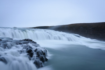 Smooth flowing water of turbulent Gullfoss waterfall