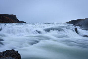 Smooth flowing water of turbulent Gullfoss waterfall