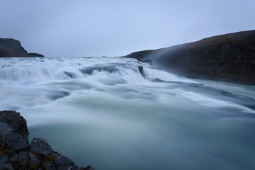 Smooth flowing water of turbulent Gullfoss waterfall