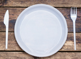 empty disposable tableware: fork, knife