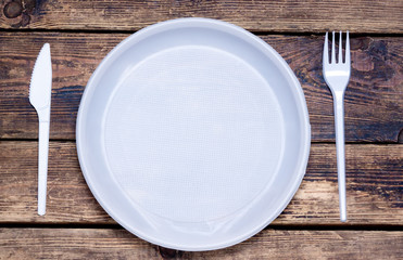 empty disposable tableware: fork, knife
