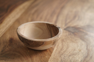 empty olive wood bowl on table