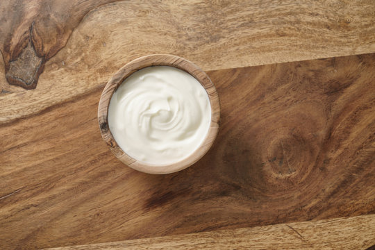 homemade organic yogurt in wooden bowl on table