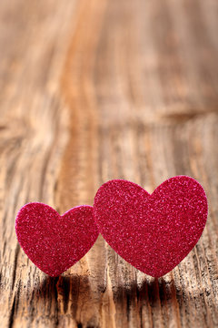 valentines day card with two hearts on wooden background