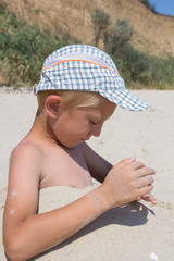 boy in headdress in the sand