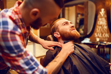 Time for a new hairdo. Handsome young bearded man came to the barber for a haircut.
hipster style. the concept of fashion and beauty.

