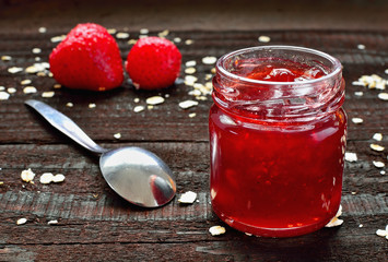 Strawberry jam on wooden table. Season fruit home made marmalade. Healthy strawberries and oatmeal.