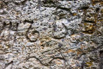Moss-grown surface of the old stone cross