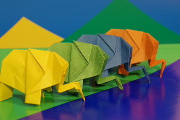 Paper origami elephant isolated on a colorful background