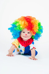 Child clown with a red nose multicolored wig in with balls