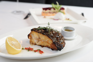 Grilled flounder with lemon and savory sauce