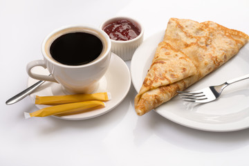 Fresh dessert pancake and strong coffee on white