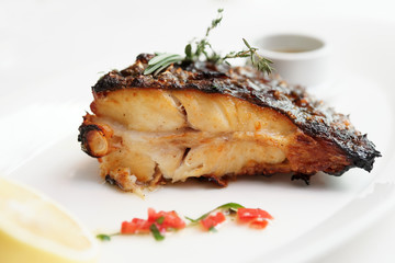 Grilled flounder with lemon and savory sauce