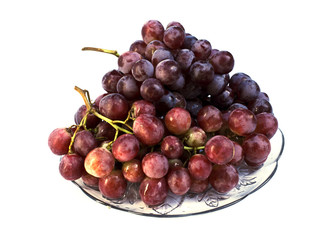 Close up of Red grape fruits on glass dish Isolated on whitebackgrounds