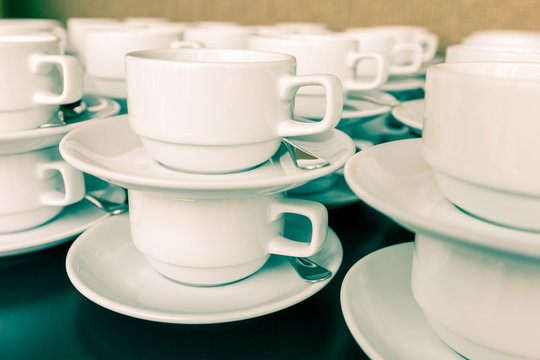 Many white cup prepared for coffee break during seminar event.