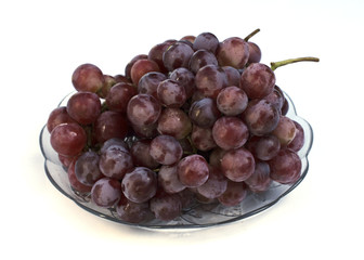 Red grape fruits on glass dish Isolated on white backgrounds