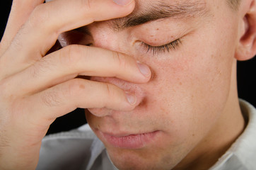 Fototapeta premium Stress and problems. Young man with a headache.