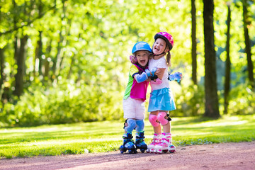 Kids roller skating in summer park