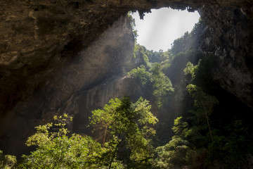 Sunlight through a cave hole in Thailand.