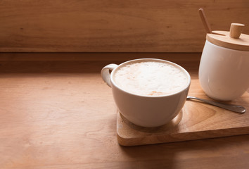 Hot art Latte Coffee in a cup on wooden table and Coffee shop.