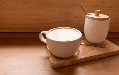 Hot art Latte Coffee in a cup on wooden table and Coffee shop.