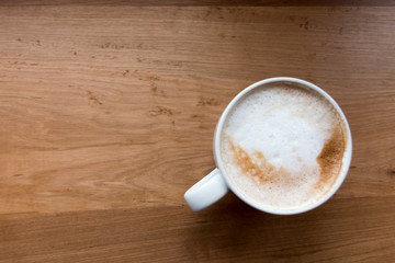 Coffee cup top view on wooden table background