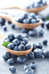 Ripe and tasty blueberries on grey wooden table