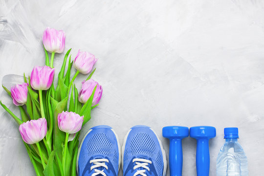 Spring flatlay composition with sport equipment and tulips.