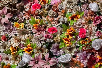 Plastic colourful flowers. Background texture