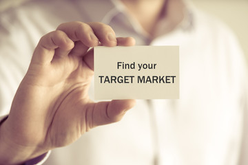 Businessman holding FIND YOUR TARGET MARKET card