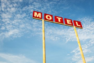 Fototapeta premium Motel Sign against a blue sky along the Route 66, USA; Concept for travel in America and Road Trip