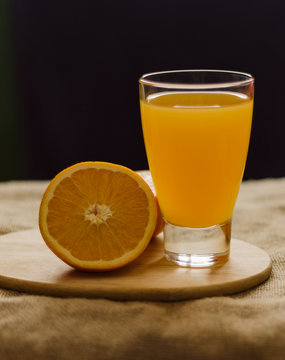 orange and glass of juice vertical view