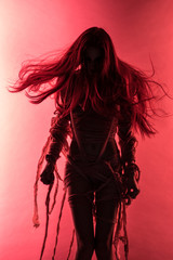 Silhouette of young mummy woman in bandage on pink background