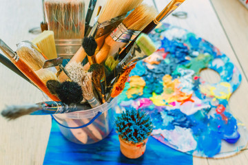 acrylic paints and Brushes. artist workshop Tools creative mood.  Working space top view from above