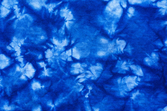 Pattern of blue tie batik dye on cotton cloth, Dyed indigo fabric background and textured, Painted blue watercolor on white cotton cloth