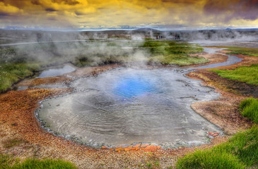 Hot steam over the source of the thermal waters, Hveravellir, Iceland. White nights in Iceland.