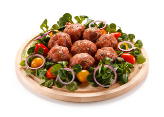 Raw meatballs on cutting board on white background