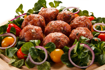 Raw meatballs on cutting board on white background