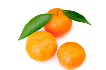 orange fruits with leaf cutout on white