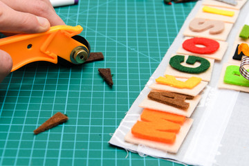Manual cutting letters with colored sheets of felt