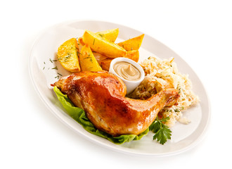 Grilled chicken leg with chips and vegetables on white background 