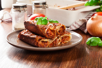 Baked cannelloni with minced meat and bechamel sauce on a plate