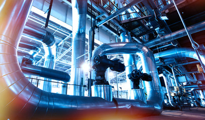 Equipment, cables and piping as found inside of a modern industrial power plant