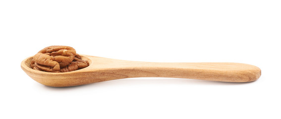 Spoon of pecan nuts isolated