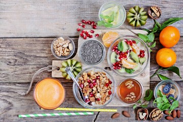 Fototapeta na wymiar Breakfast set with granola, fruits salad, fresh juice and various of topping. Healthy eating concept.