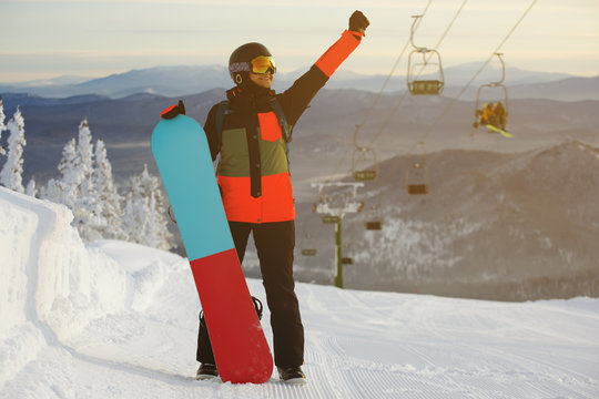 Beautiful young girl with a snowboard