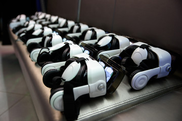Naklejka na ściany i meble many virtual reality VR helmet on dark background